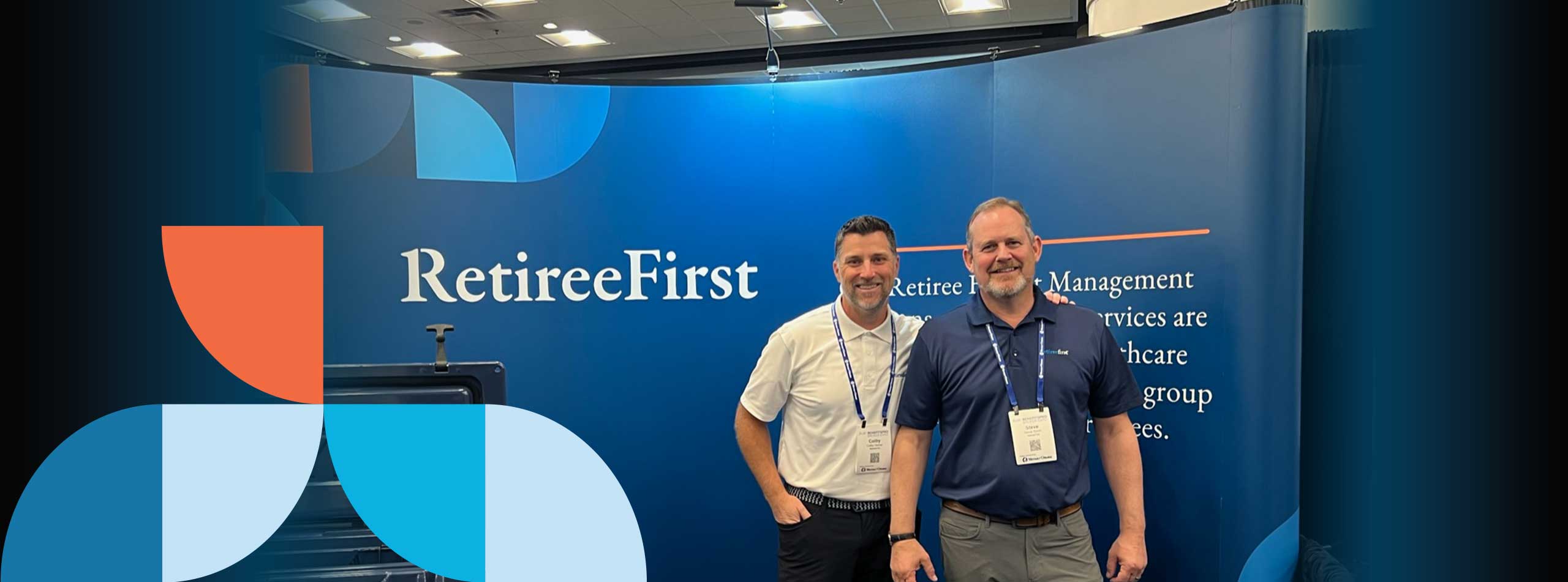 Two employees smiling in front of RetireeFirst banner