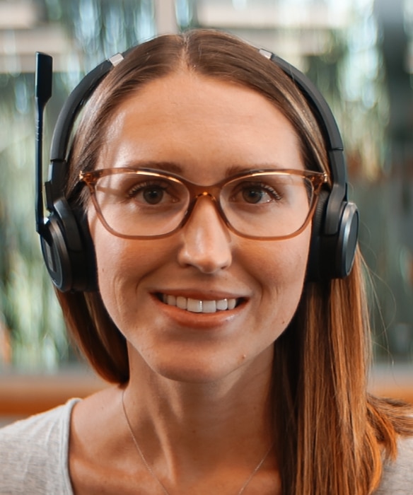 Photograph of a woman with headphones, smiling